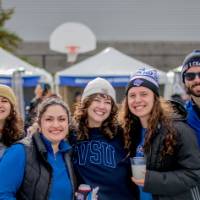 Five Lakers smile and pose for a group photo at the tailgate